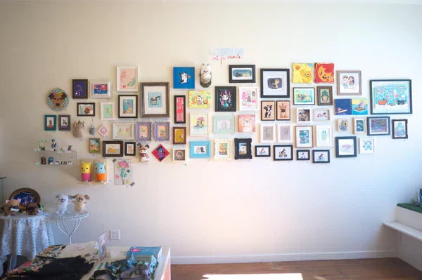 Photo of "Wonderland Art for Animals" gallery wall featuring fifty plus art pieces of cute animals. 