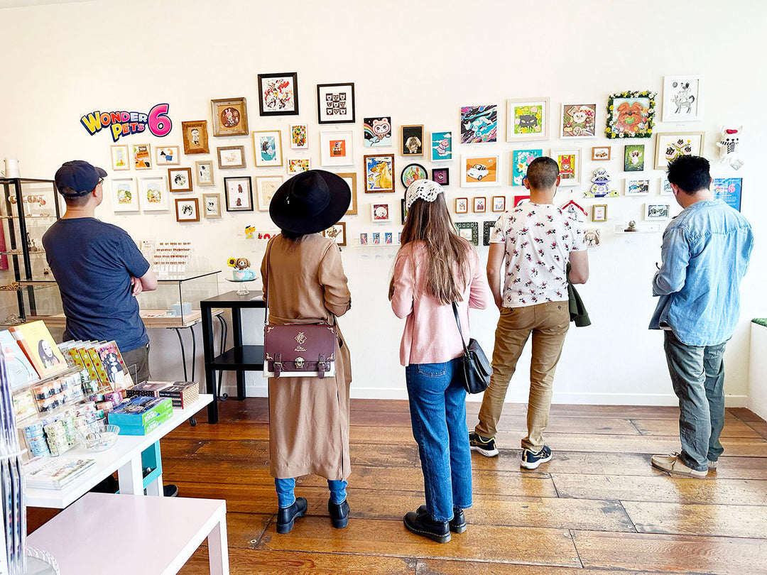 Customers looking at a gallery exhibit at Leanna Lin's Wonderland