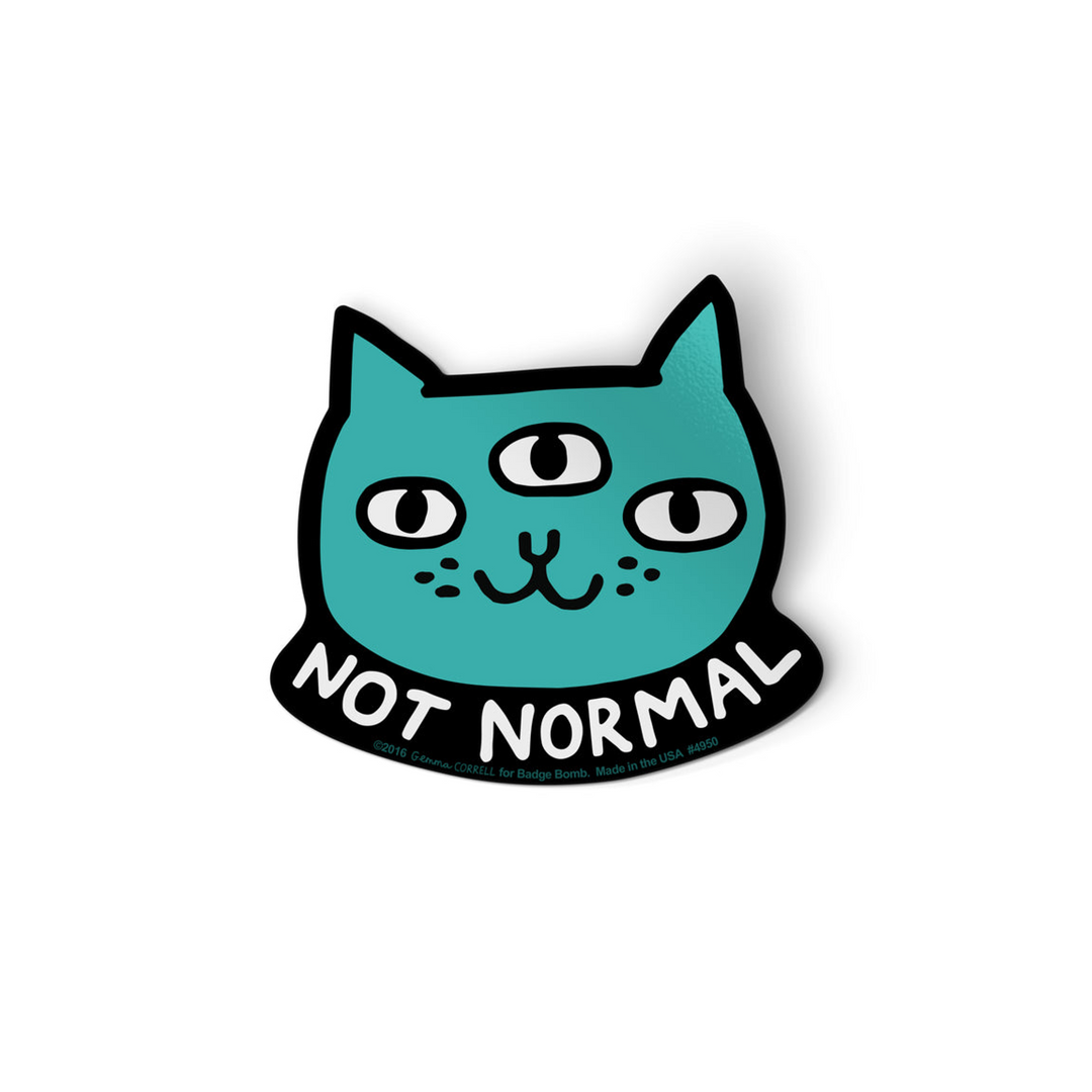 A teal cat head die-cut sticker with three eyes, outlined in black and reading &