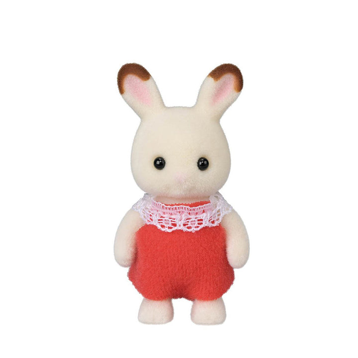 A flocked white rabbit figure with brown-tipped ears in a red outfit with white lace frill collar. With both arms down. 