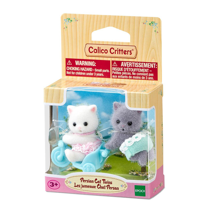 Calico Critters Persian Cat Twins toy set in its original wooden-look packaging, featuring two small cat figures in pink and green outfits riding and pushing a blue bicycle cart.