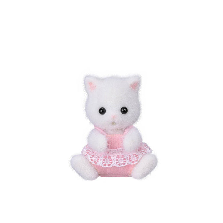 A small flocked white cat figurine wearing a pink dress with a white lace hem, centered on a plain white background.