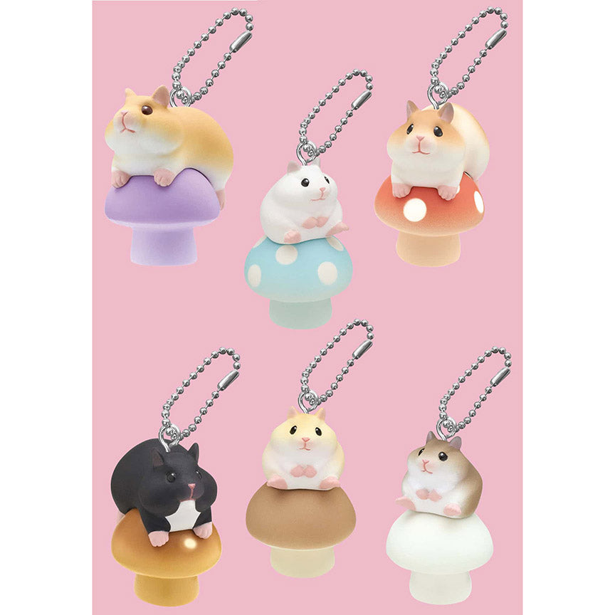 Set of five hamster-shaped keychains on mushroom bases against a pink background.