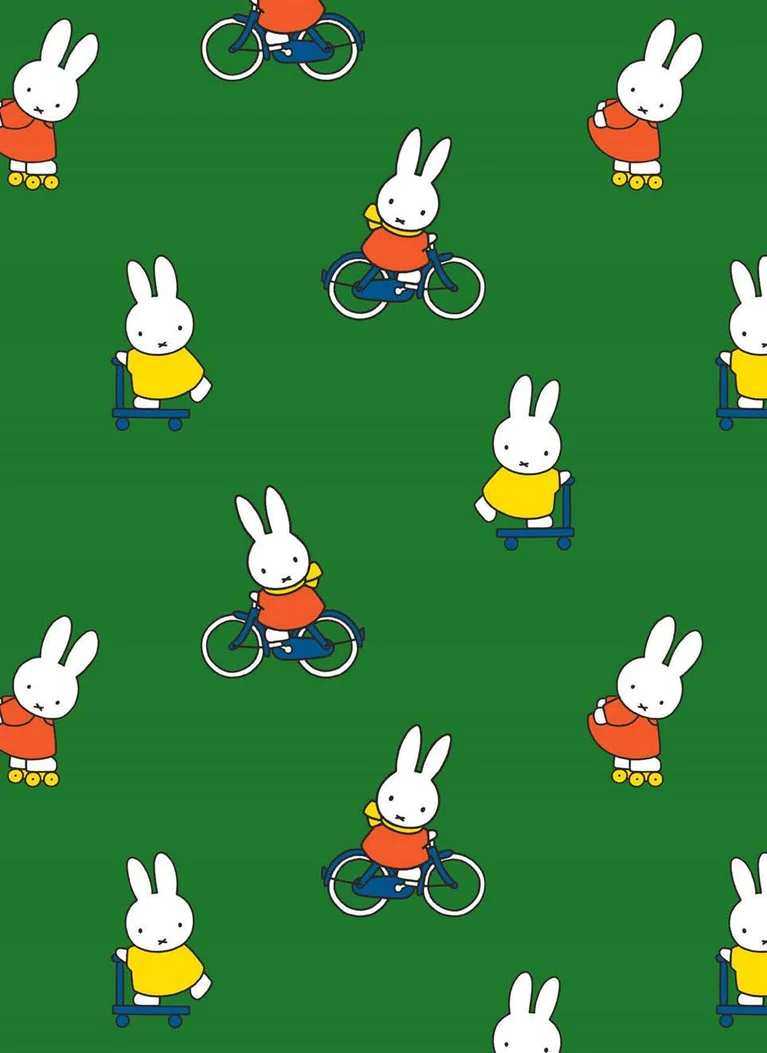 A repeating pattern of cartoon rabbits on a green background, including some riding bicycles and others on scooters. The rabbits are white with simple facial features and wear bright clothing in red, yellow, blue, and orange.