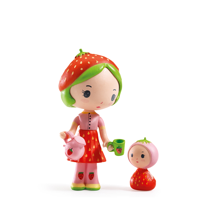 A toy figurine of a strawberry-themed girl with pale skin, green hair, and a strawberry beret. She holds a pink strawberry teapot and a green mug, with a smaller matching strawberry doll beside her. Figurines are displayed on a white background. 