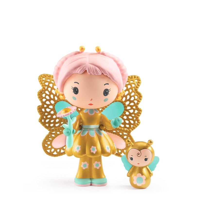 A toy figurine of a pale-skinned, fairy-like character with pink hair, a gold ornate dress with turquoise floral details, and large gold lace wings. She holds a flower with pink petals in one hand and stands next to a smaller matching figurine styled as a small golden butterfly with cute face. Figurines are displayed against a while background. 