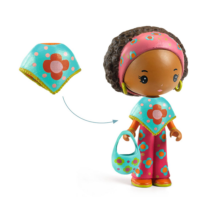 This photo demonstrates the removable turquoise floral-patterned poncho the doll can wear.  