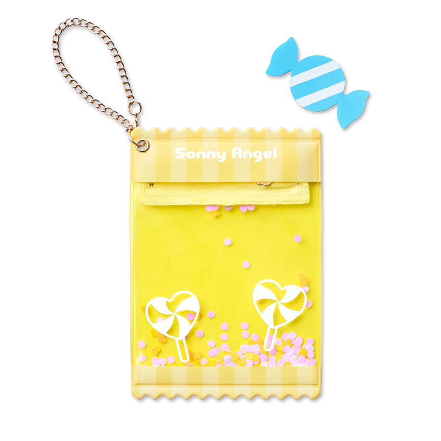 A yellow candy-themed mini-figure holder pouch with a gold chain strap, featuring 'Sonny Angel' branding, candy illustrations, and pink confetti, shown on a white background with a small blue candy-shaped card.