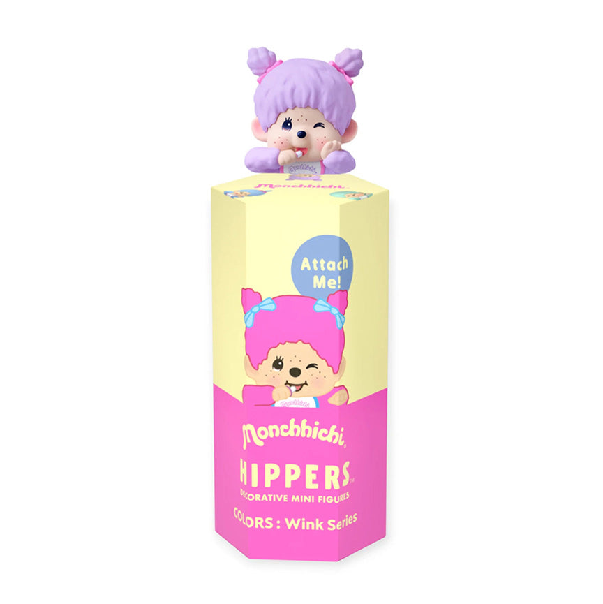 A Monchhichi Hippers decorative mini figurine in its packaging, featuring a purple-haired animal-like Monchhichi on top of a pastel yellow and pink display box.