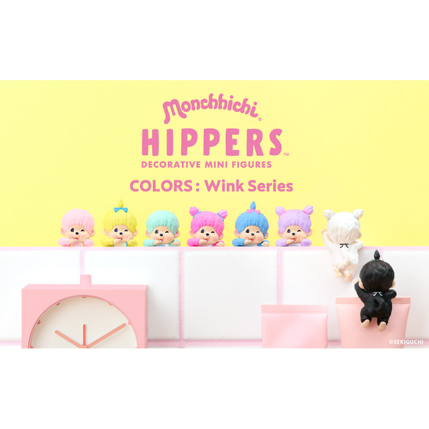 Monchhichi Hippers Decorative Mini Figures Colors: Wink Series, featuring a lineup of six colorful mini figures on a white shelf against a pastel yellow background, with a pink clock and a black figure on the right. Mochhichi colors include light pink, yellow, light green, pink, blue, purple, white, and black.