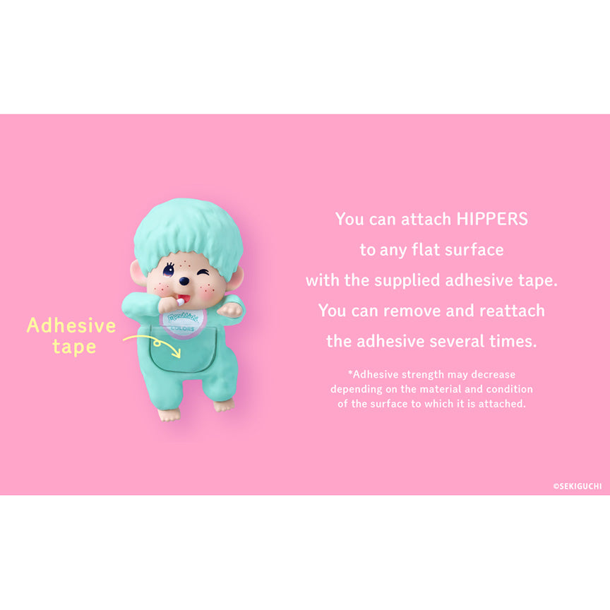 A Monchhichi figure with bright aqua hair sits against a pink background with explanatory text saying that "You can attach hippers to any flat surface with supplied adhesive." and that you can "remove and reattach the adhesive several times."
