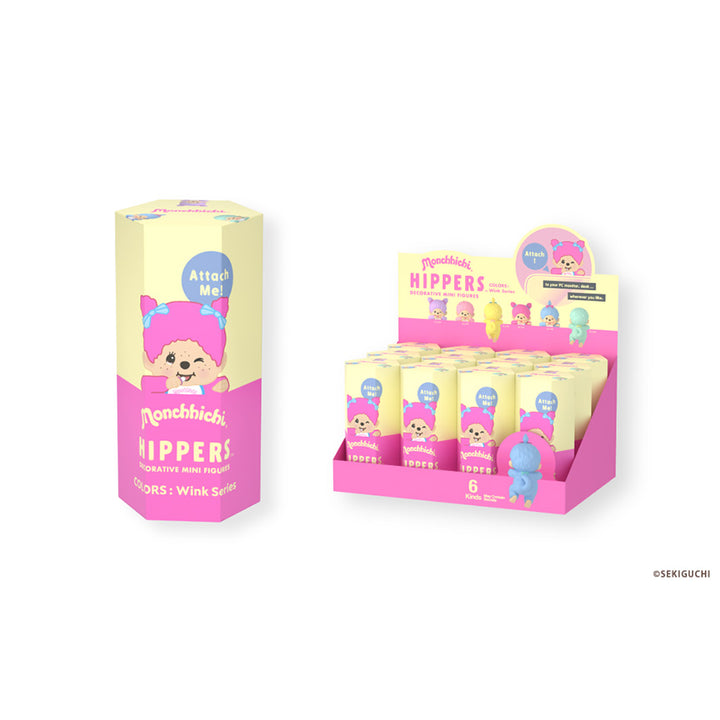 A retail display box and a single cylindrical package of Monchhichi hippers featuring a pastel pink and cream design with a cartoon character and the text &