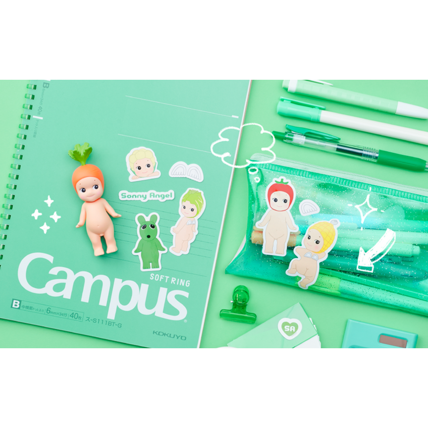 A mint green stationery set featuring a spiral-bound notebook and cute character stickers, alongside a translucent green pen pouch, pens, and small accessories on a matching mint background.