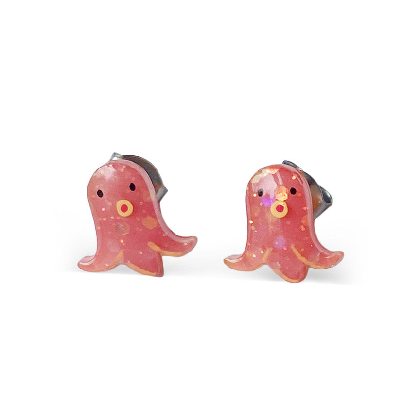 A pair of sparkly pink stud earrings shaped like stylized squids with cute faces.