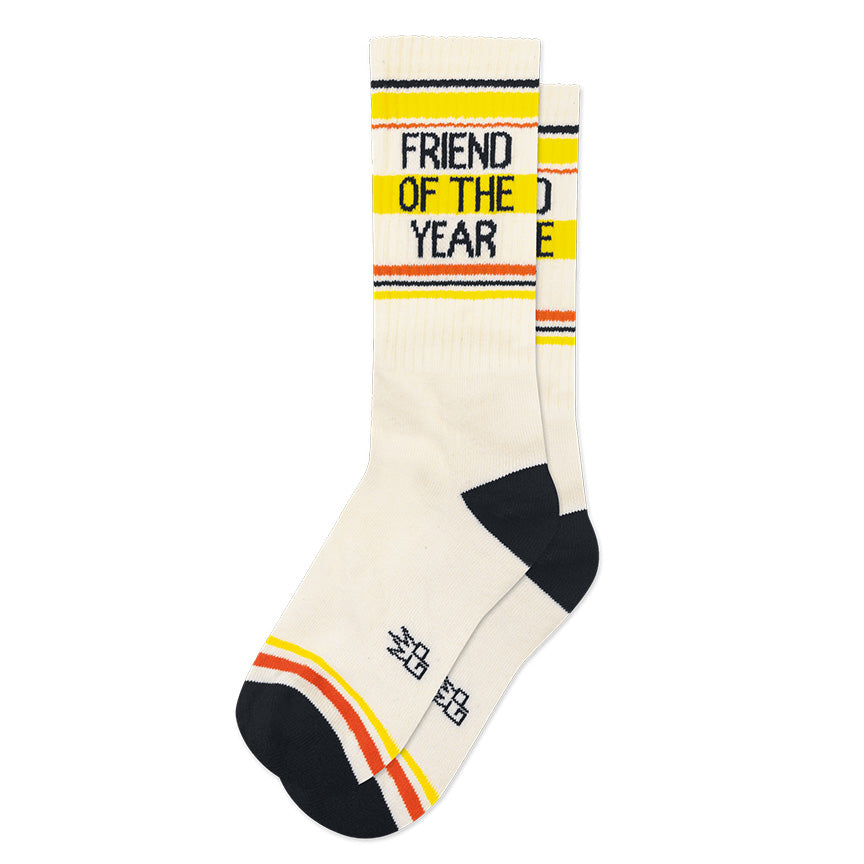 White, black, yellow, and orange retro gym-style crew socks with the text &