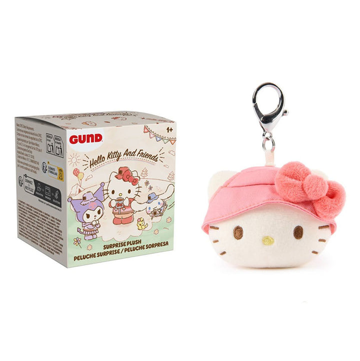 Keychain with Hello Kitty in a pink hat with a bow alongside its box on a white background.