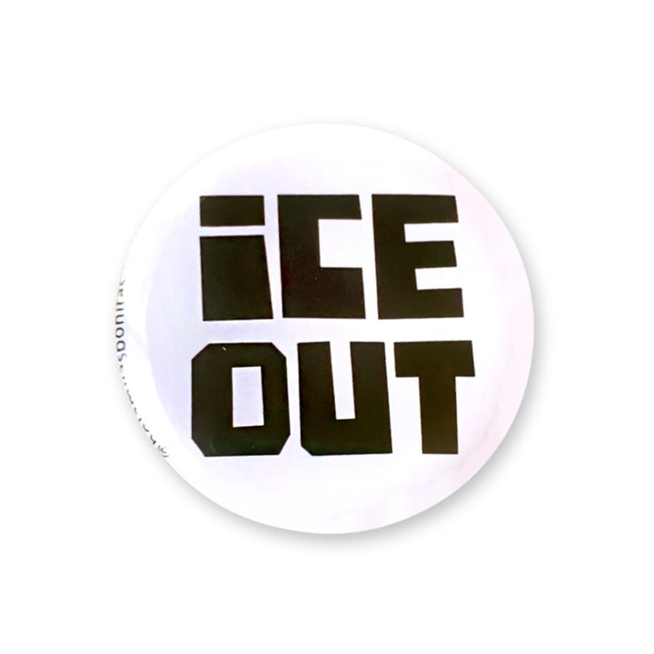 A round white button badge featuring the text &