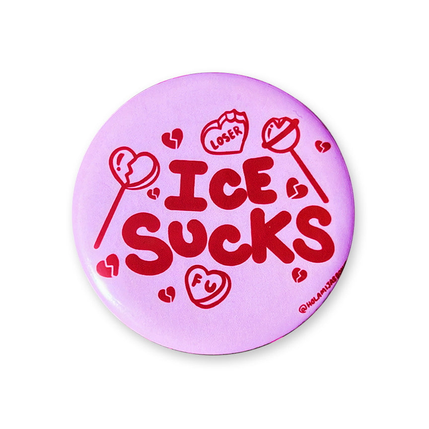 A round pin badge with a light purple background and red text reading &