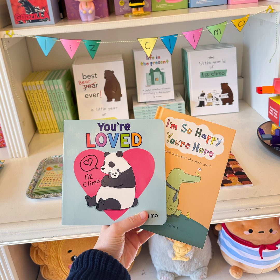 A hand holding the books "You&