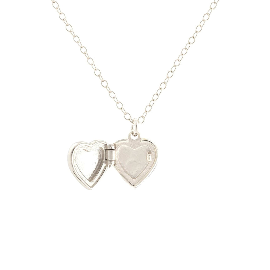 A silver heart-shaped locket pendant necklace on a delicate silver chain, shown open with space inside for a photo, against a plain white background. 