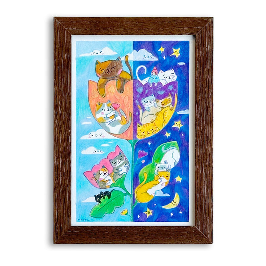 A framed art print featuring a whimsical two-panel illustration of cats in colorful flower shapes in the day and night, set in a dark brown wood frame against a white background.