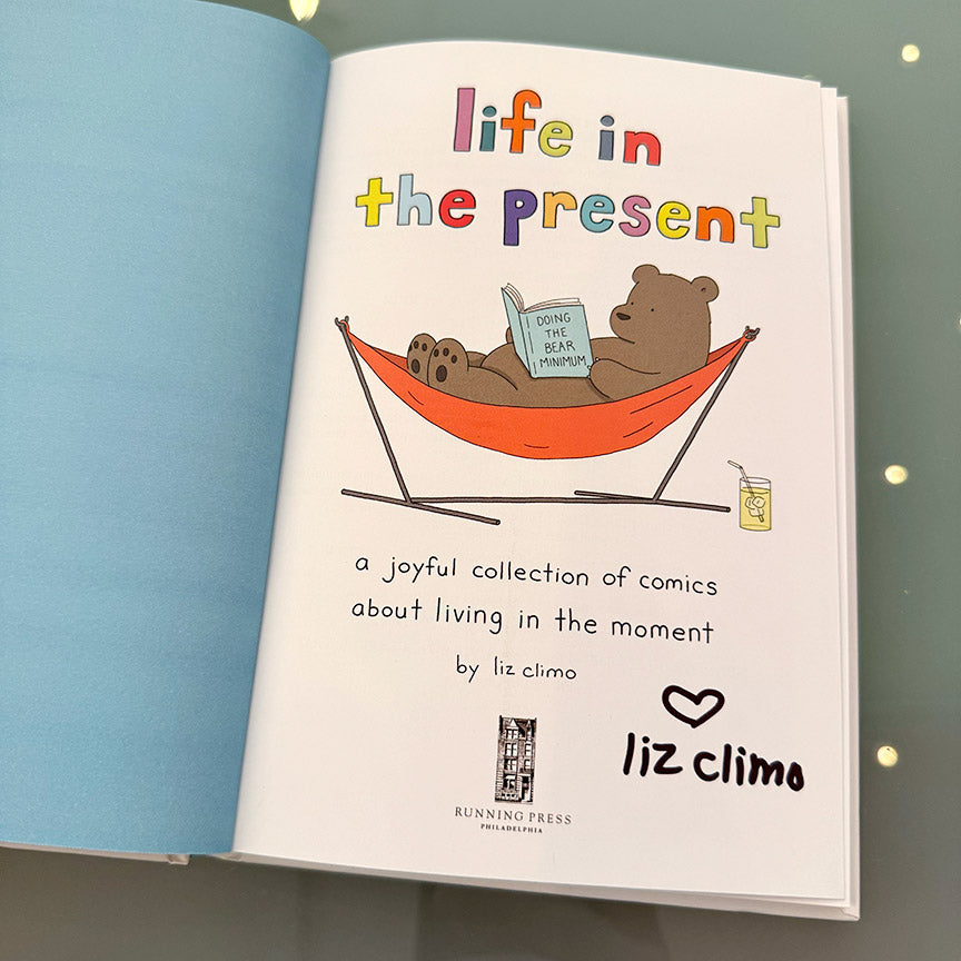 Two pages from the book "Life in the Present" with a signature from the author Liz Climo.