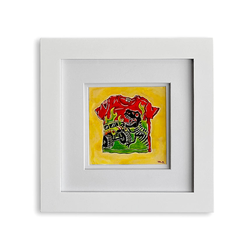 A square framed art print featuring a colorful illustration of a red dinosaur and monster truck themed T-shirt with green and black details on a bright yellow background, set in a white frame with a white mat.