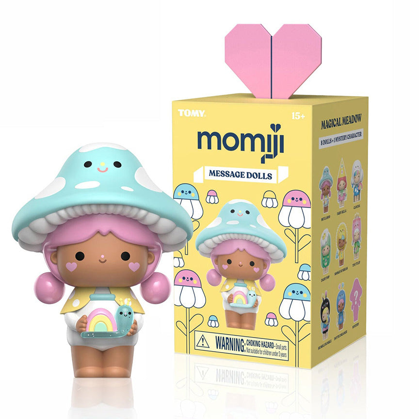 Vinyl figure of a girl with pink hair wearing a blue mushroom hat, holding a smaller rainbow snail friend character. Vinyl figure is standing next to it&
