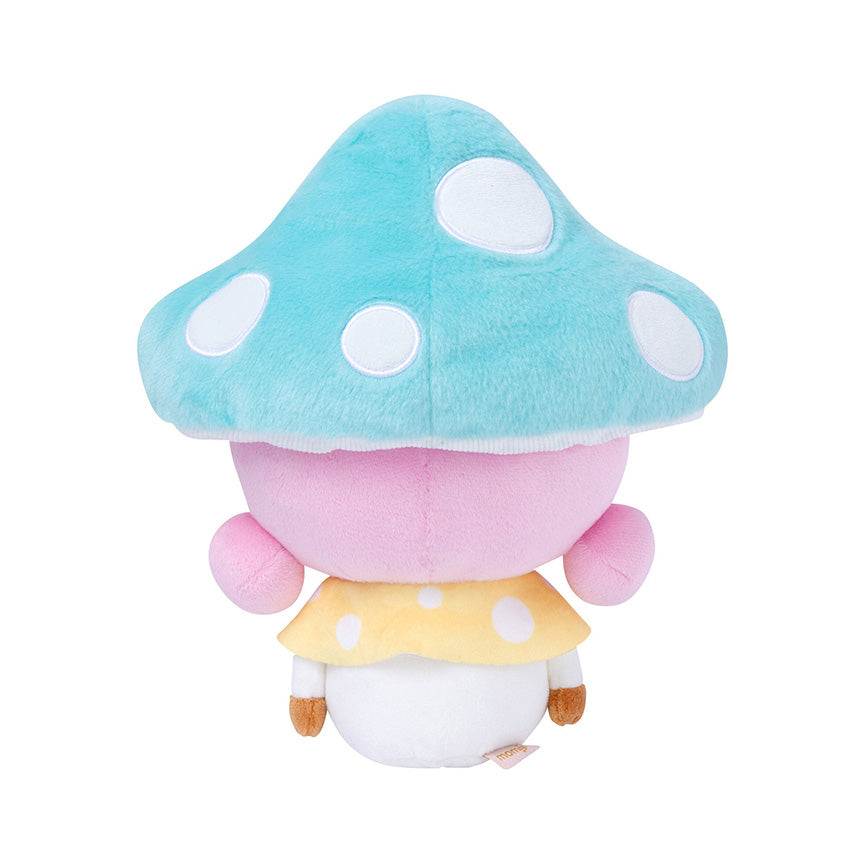 Back view of a plush of a girl with brown skin and pink hair wearing smiling blue mushroom hat and yellow and white outfit. 