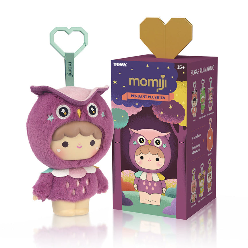 A Momiji pendant plush toy in a purple owl costume stands next to its illustrated retail box on a white background. The plush has a mint green heart-shaped keychain loop attached.