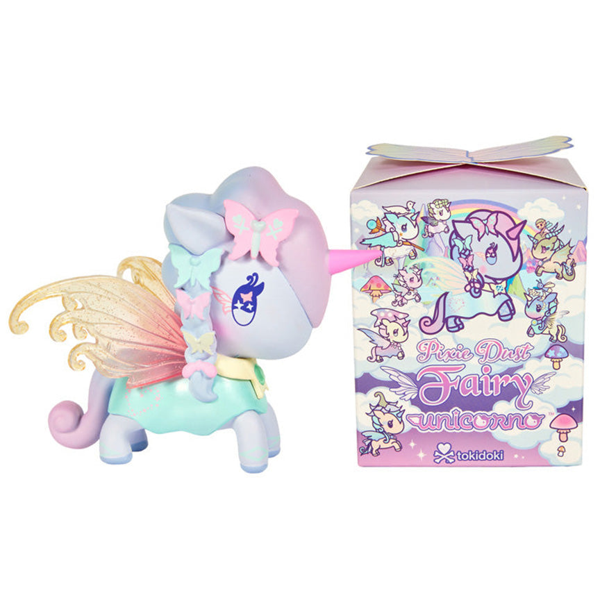 A pastel-colored winged unicorn figurine stands beside its illustrated "Pixie Dust Fairy" retail box on a plain white background. The unicorn has a lavender body, pink horn and fairy wings, and mint dress