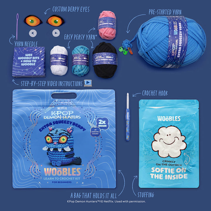 All materials included in Wooble kit (yarn needle, yarn, custom plastic eyes, themed crochet hook, instructions, stuffing, and reusable zip bag) on a blue background. 
