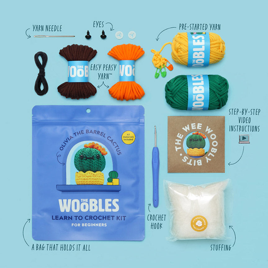 Crochet kit with yarn, needles, and tools on a blue background.