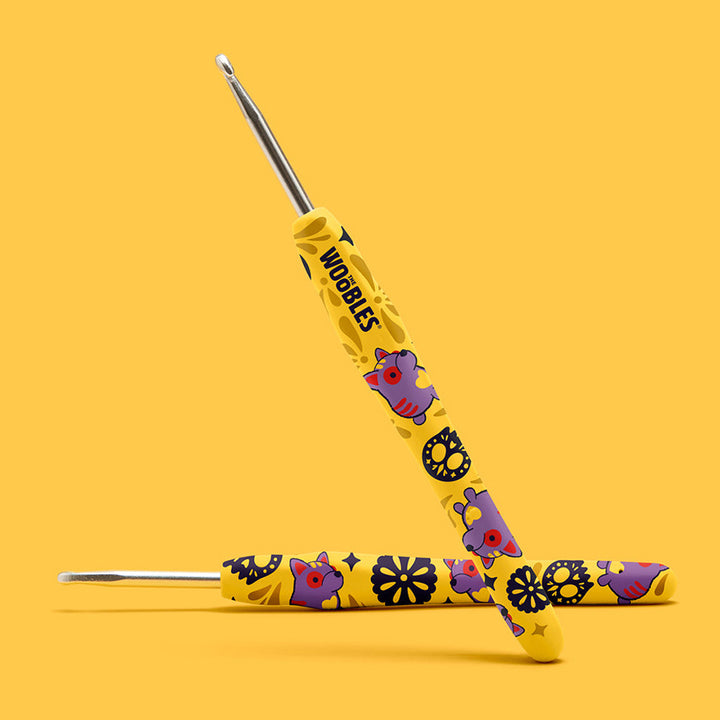 A yellow alebrije dog and skull design crochet hook. 