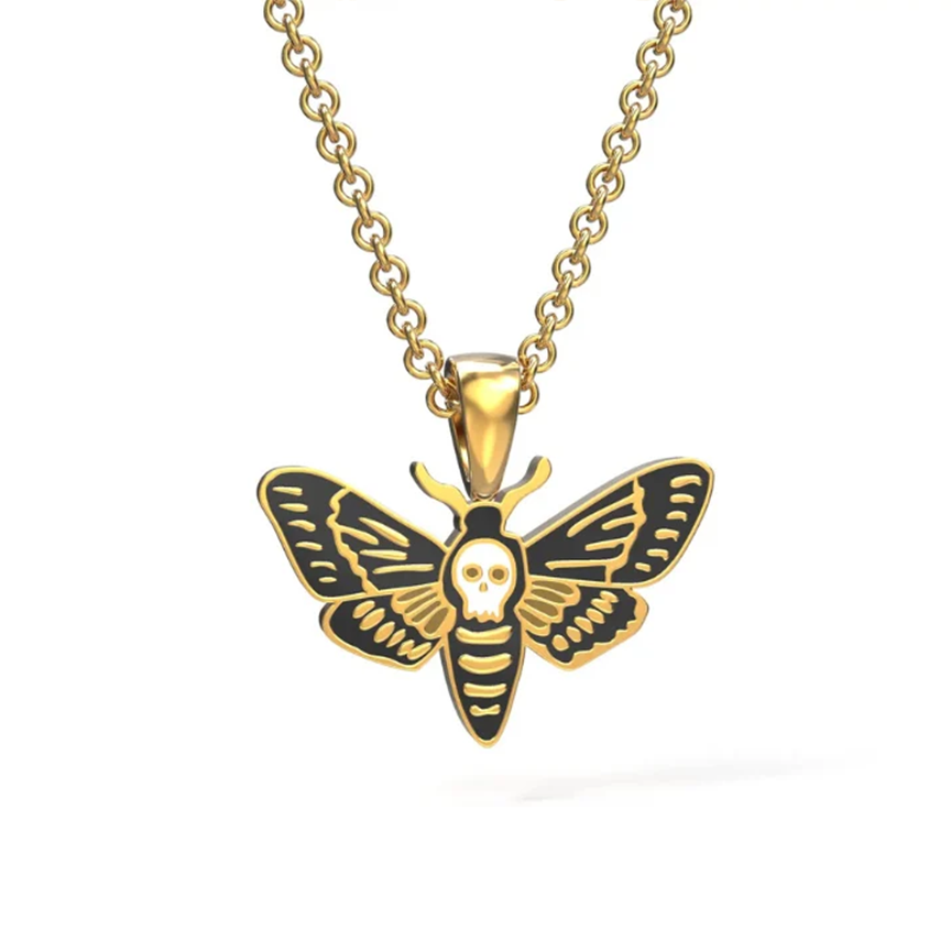 Gold moth pendant necklace with black and white enamel detailing, featuring a skull motif on the thorax, shown on a clean white background.