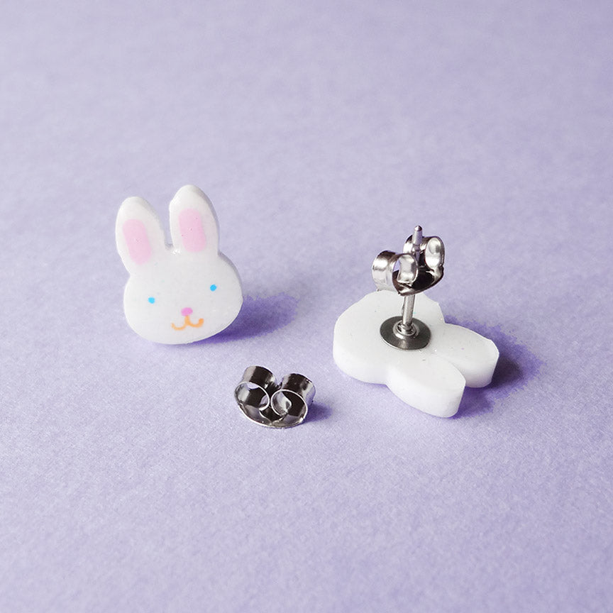 A pair of bunny-shaped stud earrings, one displayed face up, and the other face down, showing the post.