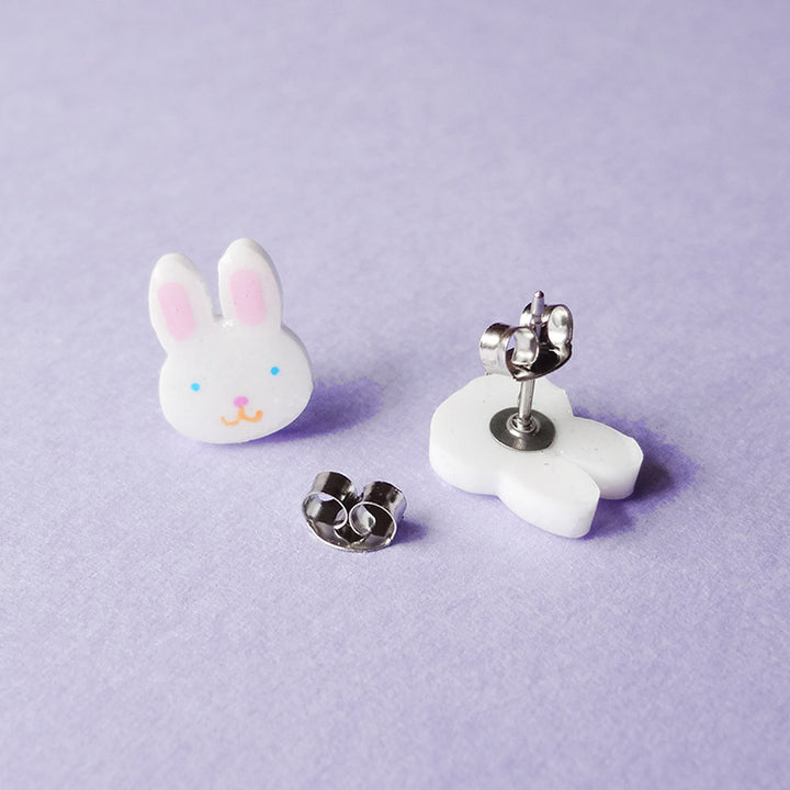 A pair of bunny-shaped stud earrings, one displayed face up, and the other face down, showing the post.
