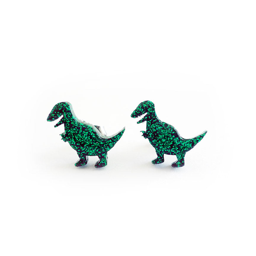 A pair of green glittery T-Rex stud earrings.