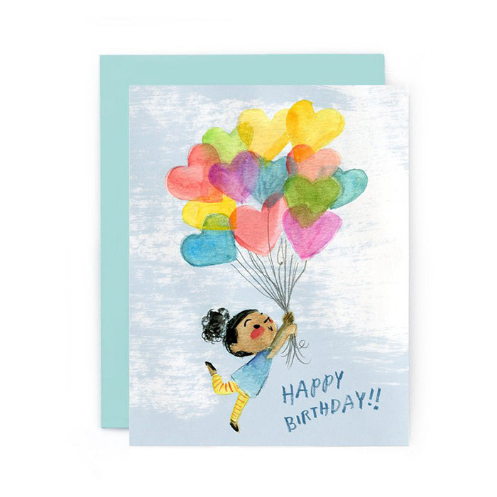 A colorful birthday card with an illustration of a girl with curly hair and striped leggings holding a bunch of heart shaped balloons and the text "Happy Birthday!!".