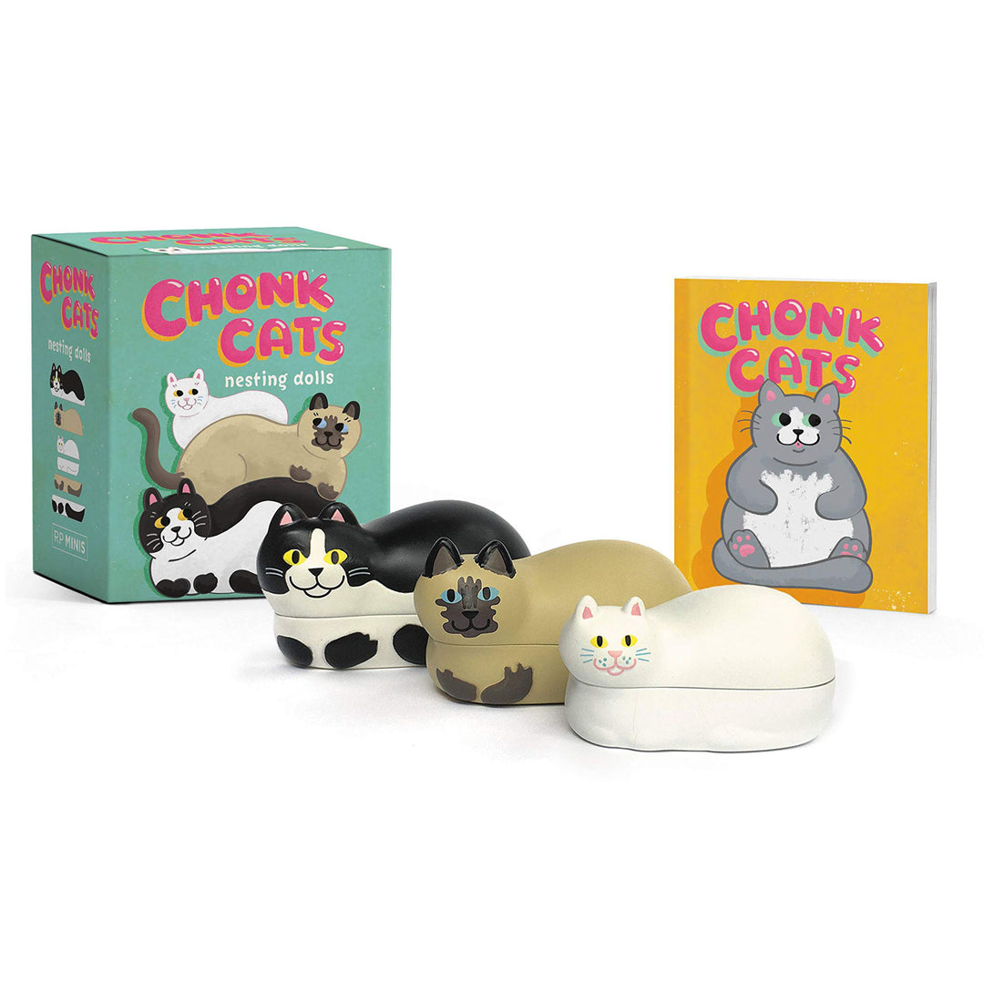 Three laying down cat figure nesting dolls, each able to fit inside another. One white cat, one siamese, and one tuxedo. Picture also shows illustrated box and booklet. 