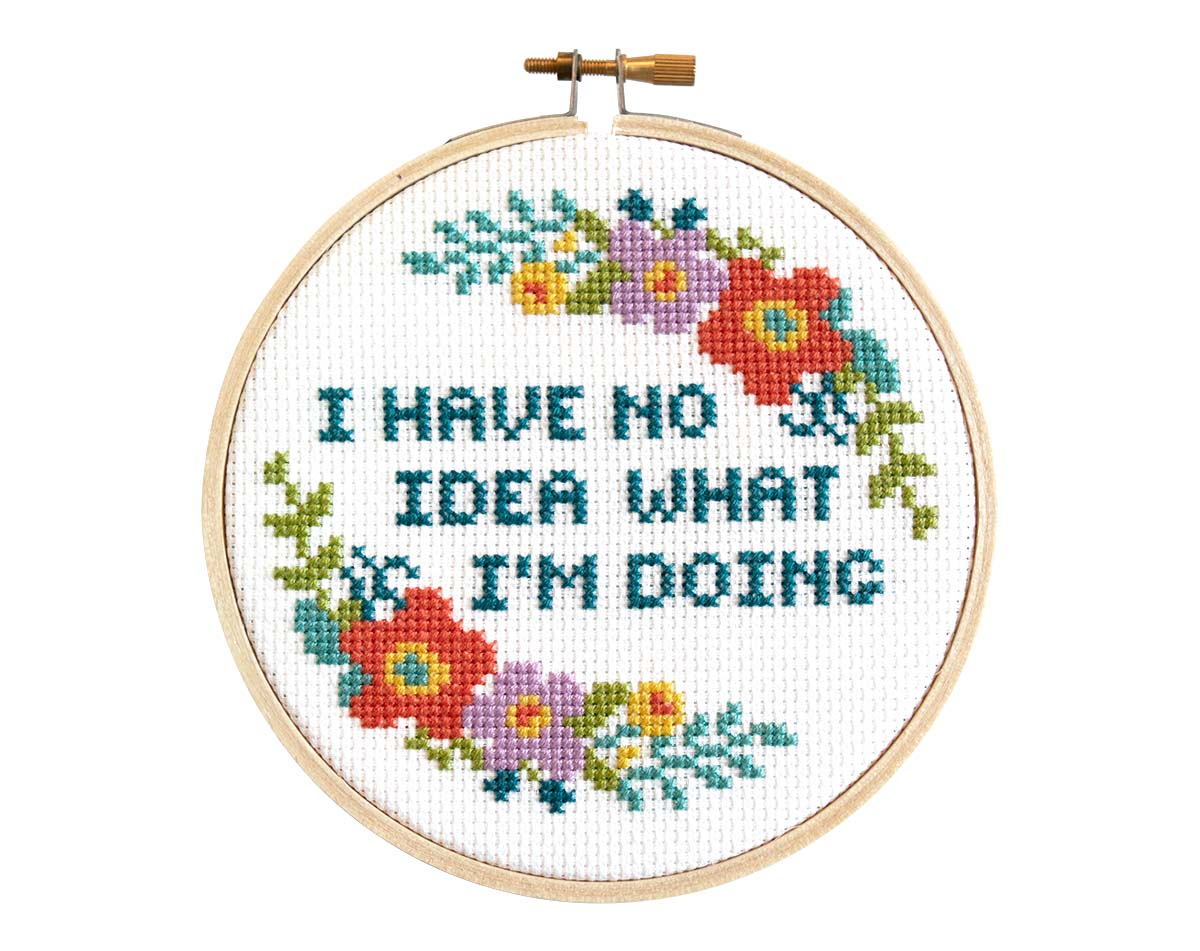 Cross-stitch with the text "I have no idea what I'm doing" and a floral border.